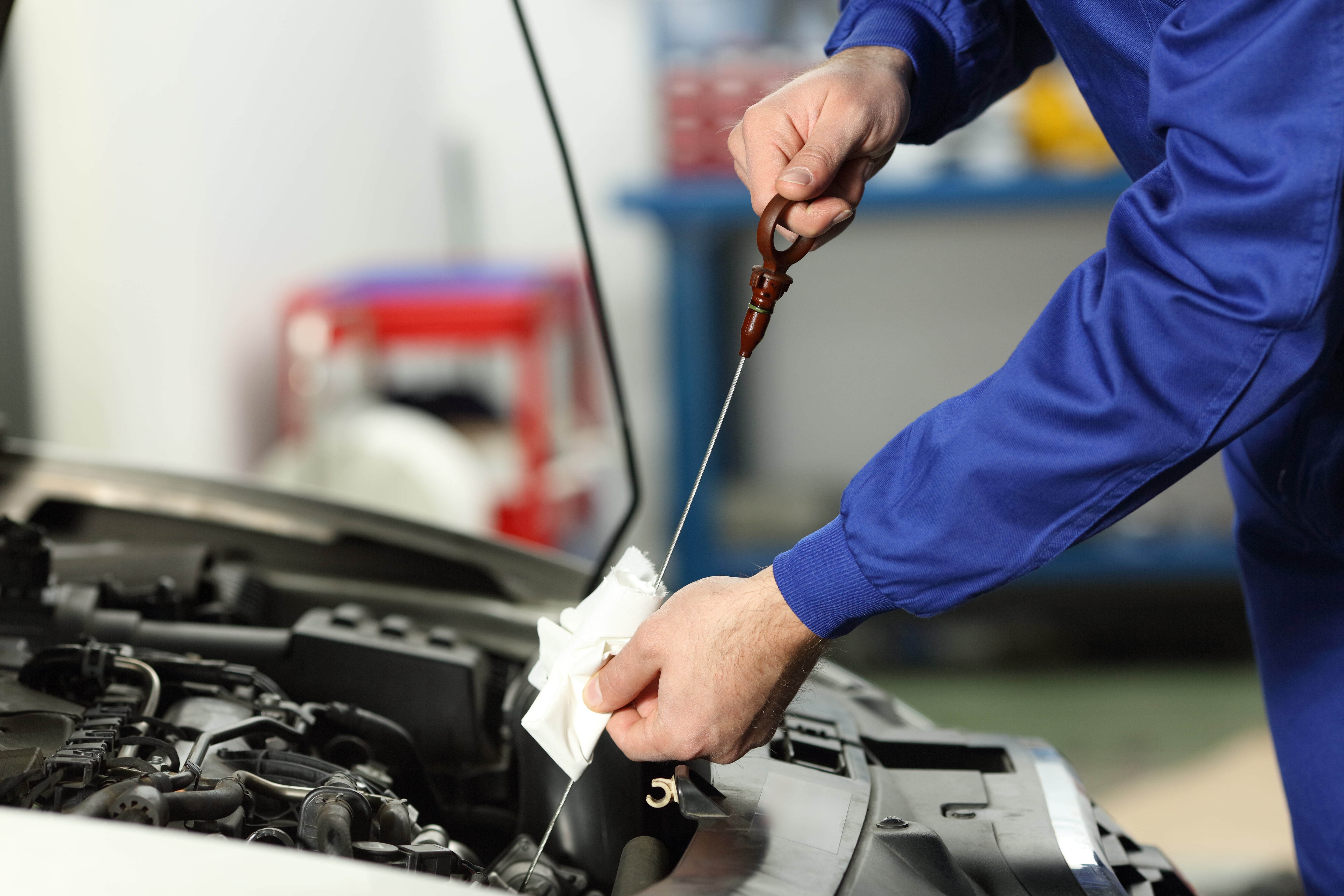 Mechanic performing an oil change on a car